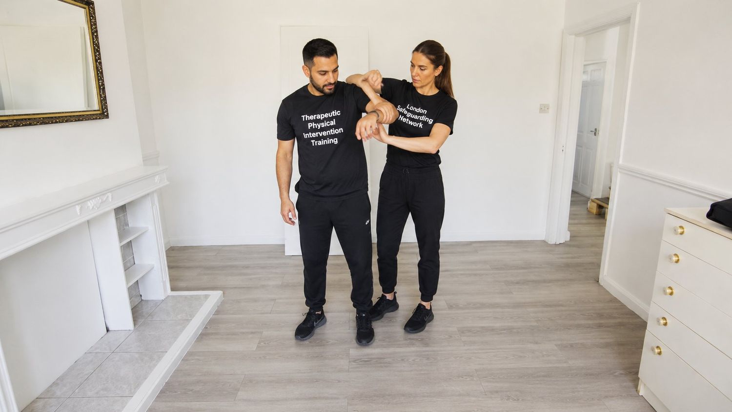 Therapeutic physical intervention training session — controlled, supportive technique.
